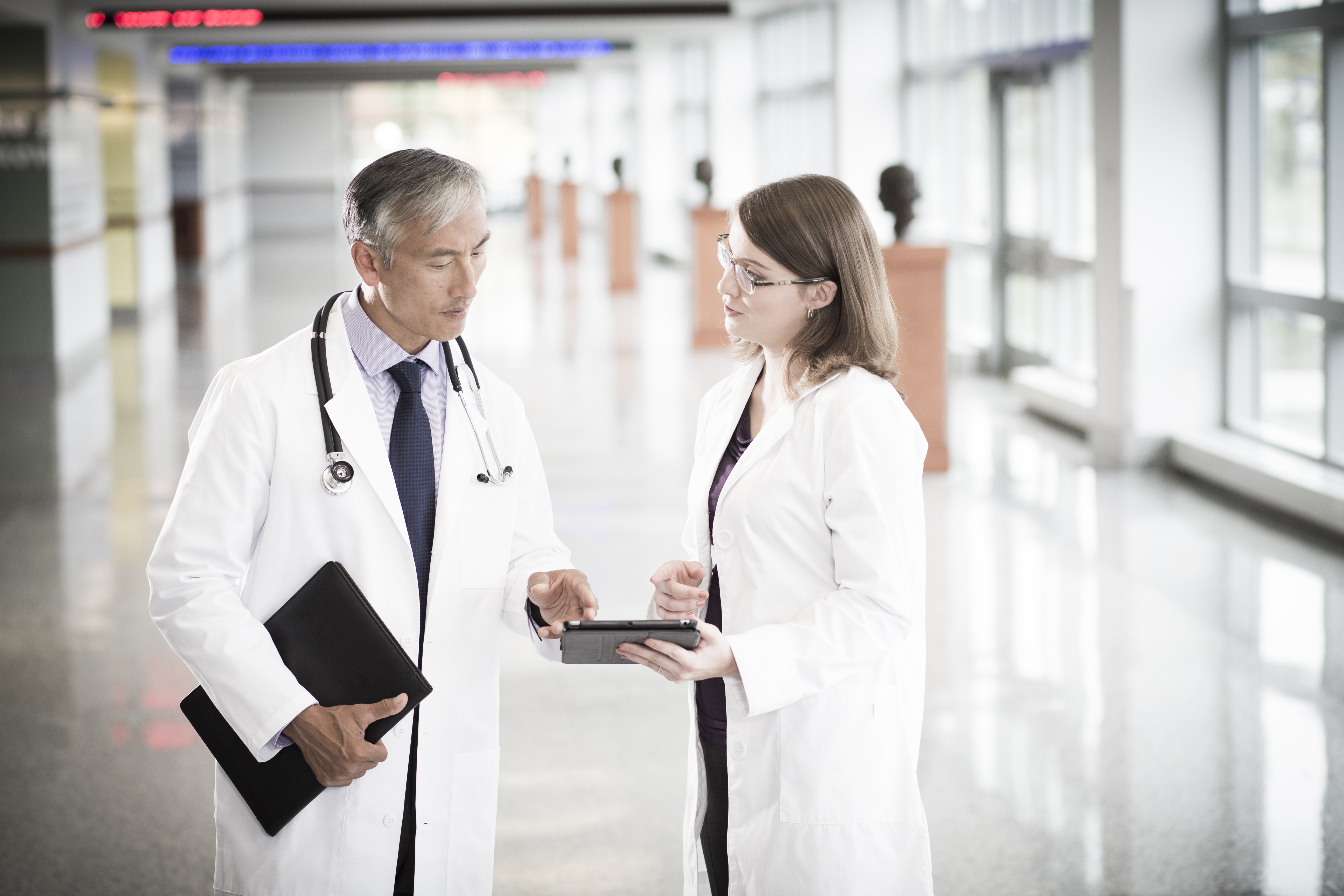 Medical professional speaks with a consultant.